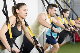 Group of people working out on TRX equipment