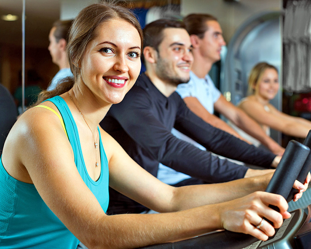 Woman smiling on stationary bike